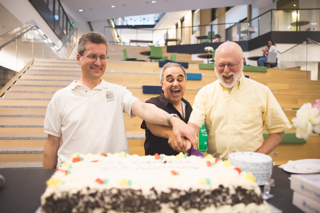 Dave Kotz, Panagiotis Metaxas, and Scot Drysdale cutting cake
