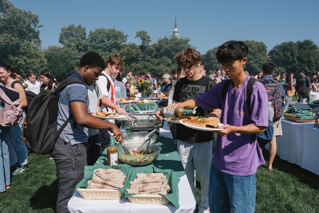 People gathering food at a cookout