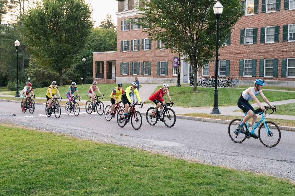 Cyclists riding through campus