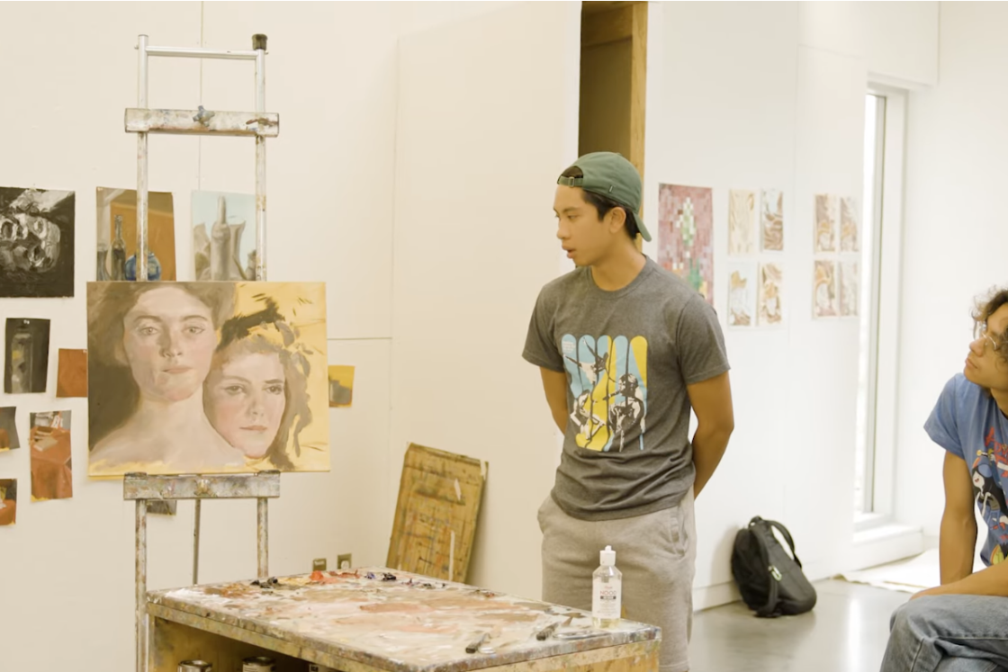 A student looks at a painting during class