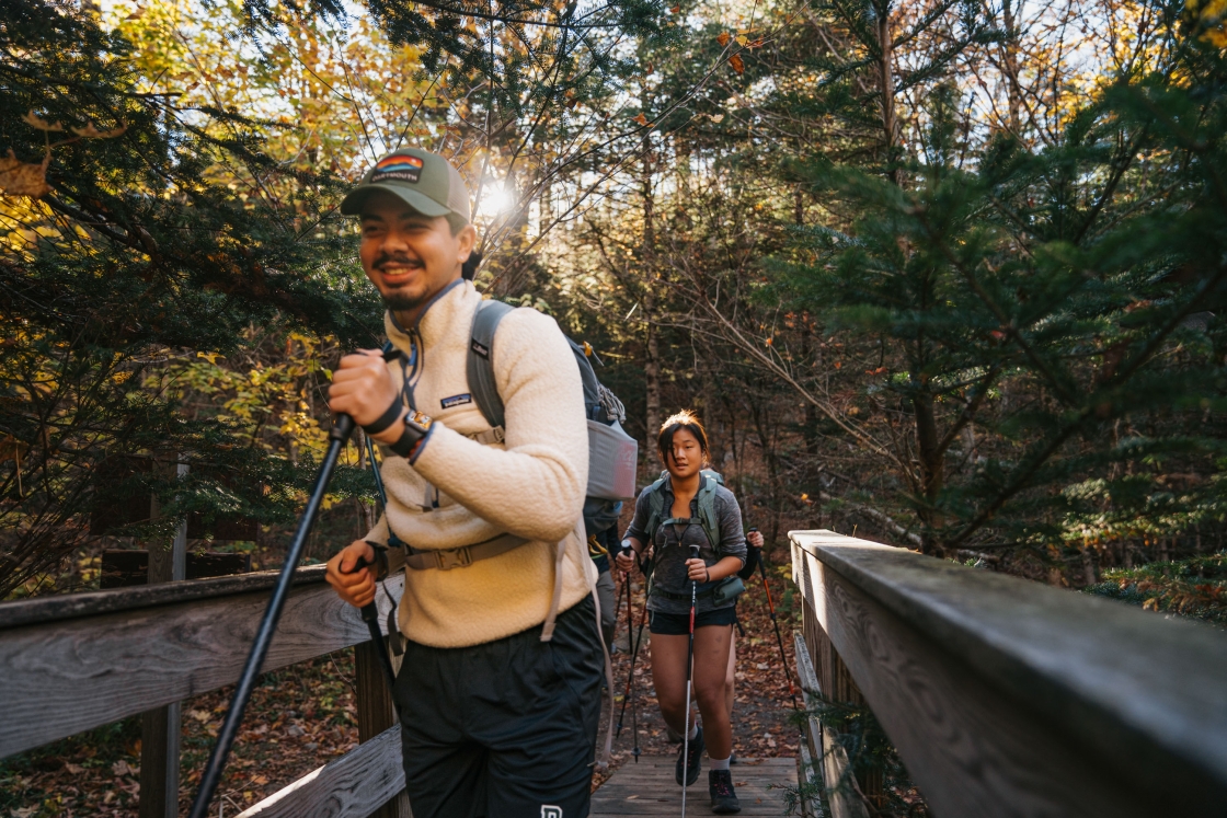 Students hike over a bridge on Moosilauke