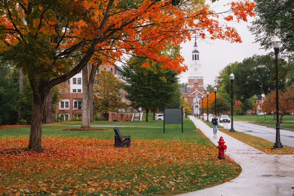 Orange leaves litter the ground, Baker Library in the background