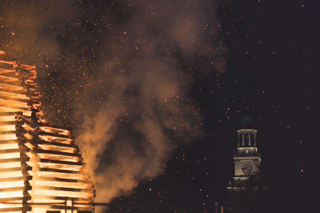 Lit bonfire in front of baker tower