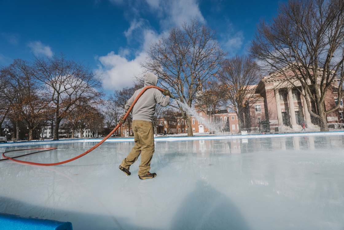 Person flooding ice rink with a hose