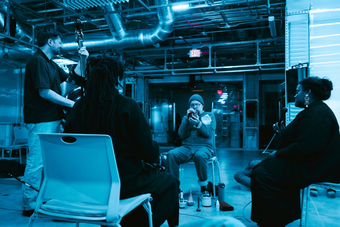 Band playing music in a blue-lit room