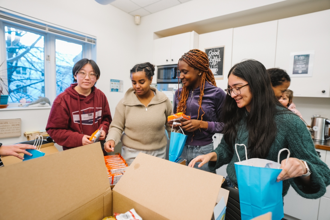 First Gen Students and a friend making goodie bags