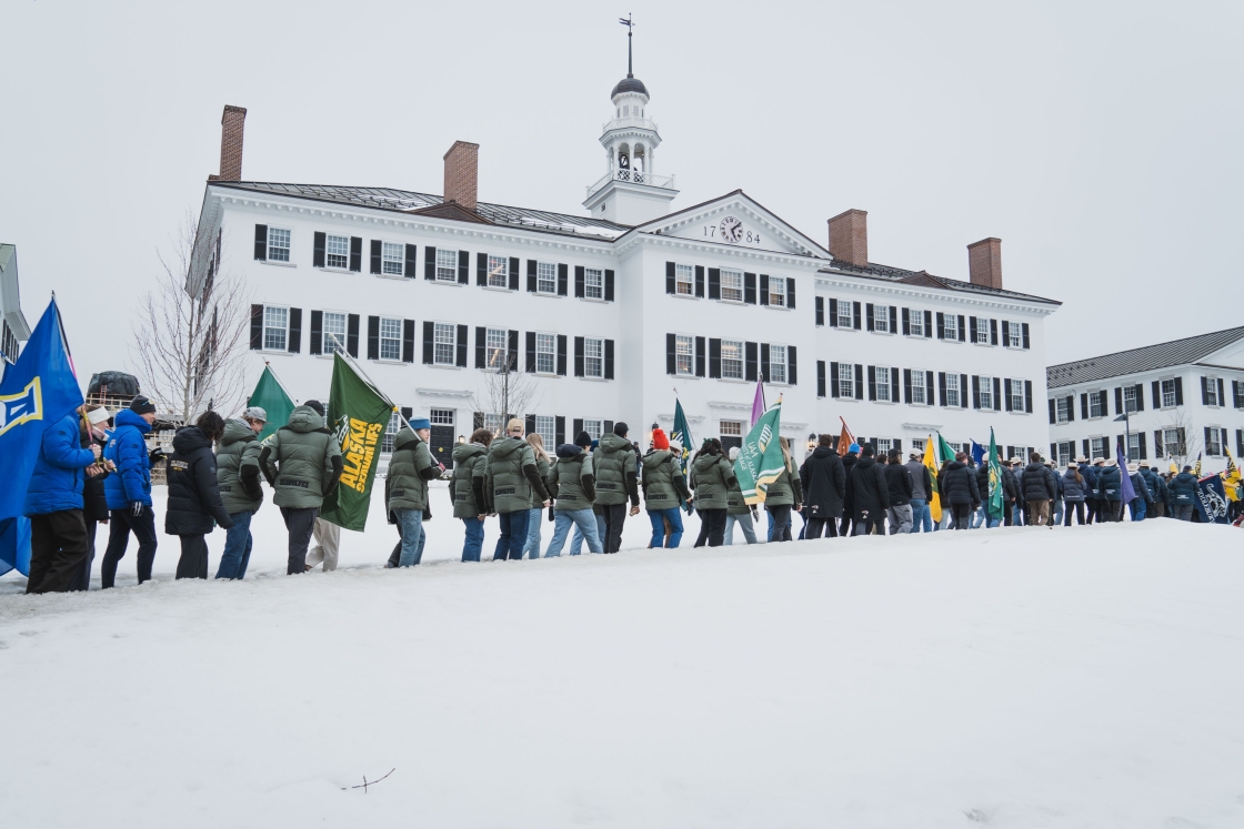 Ski teams parade by Dartmouth Hall