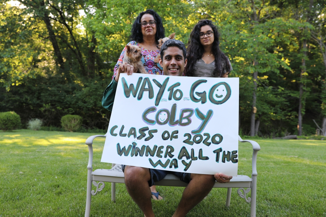Family of Colby '20 holding a poster
