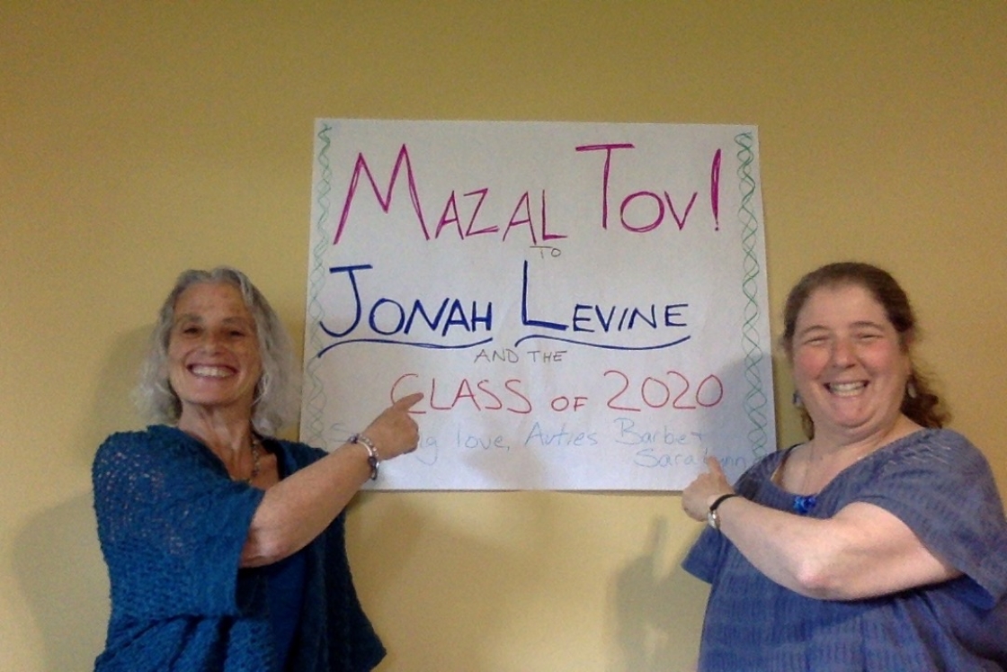 Jonah Levine's family members point at a poster