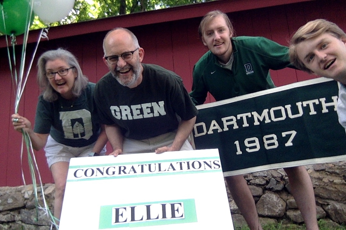 Family and friends of Ellie Garlick hold congratulations signs