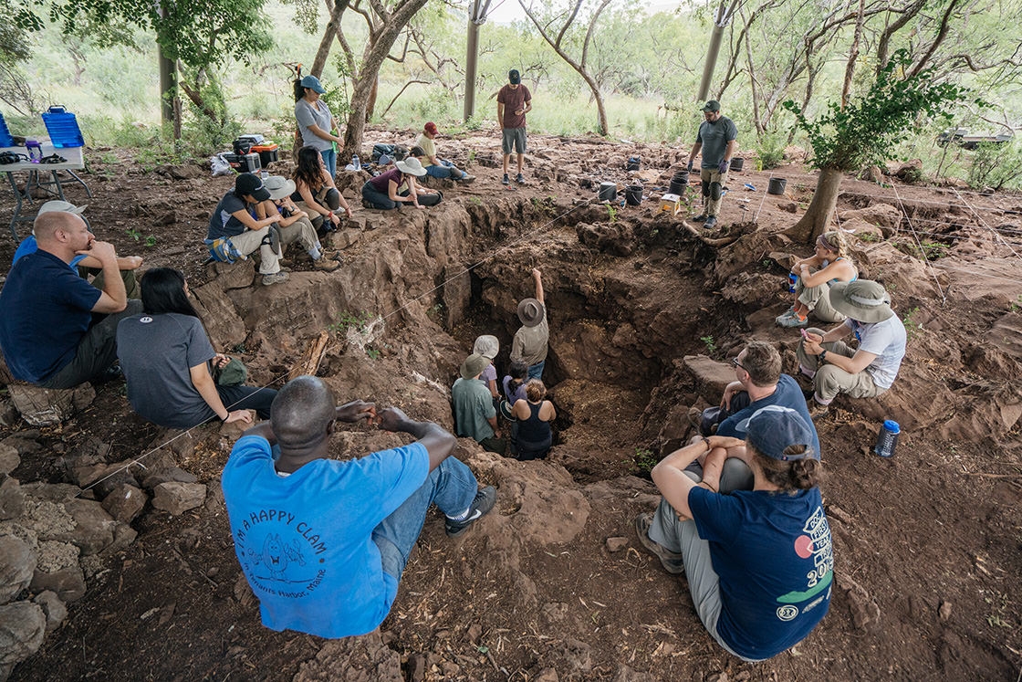 Lee Berger (center, in hat) points fossils of Australopithecus sediba