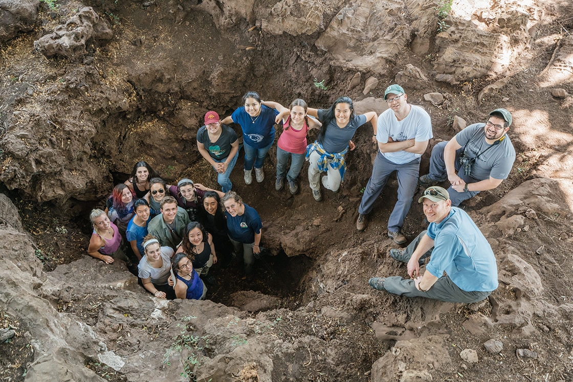 class poses at the Malapa dig site