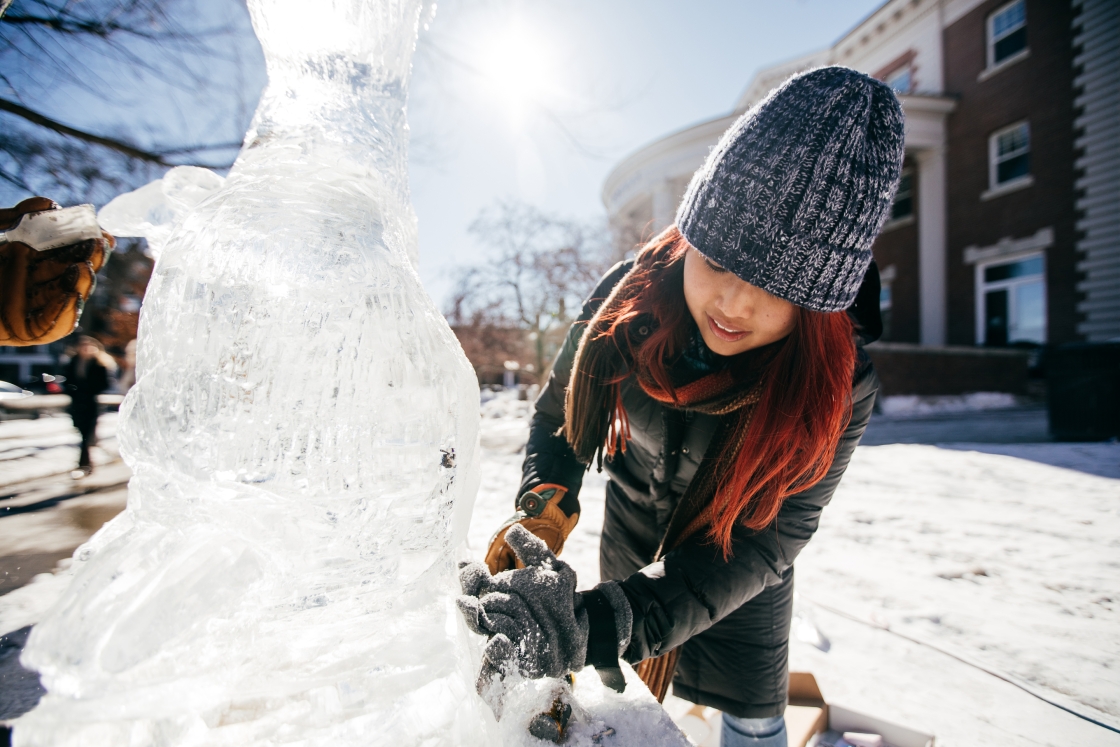 Students carve blocks of ice into sculptures for the annual ice sculpture contest