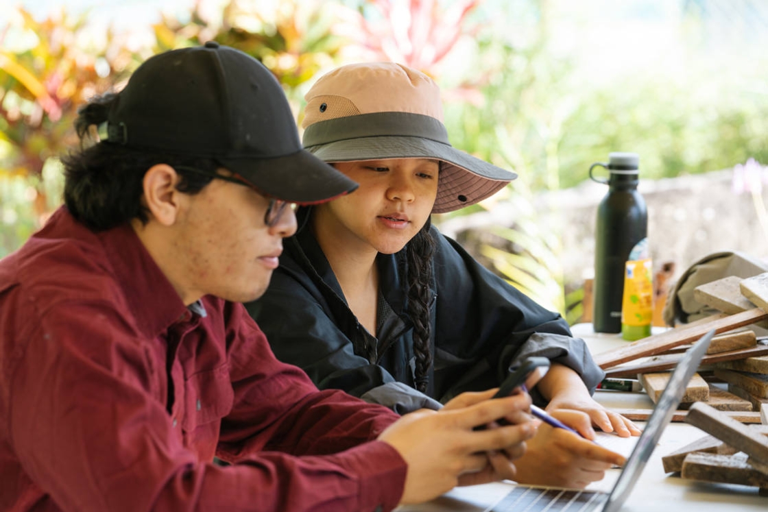 Angel Aguilar '22 and April Lam '20 work on their catalog of plants in the garden. After