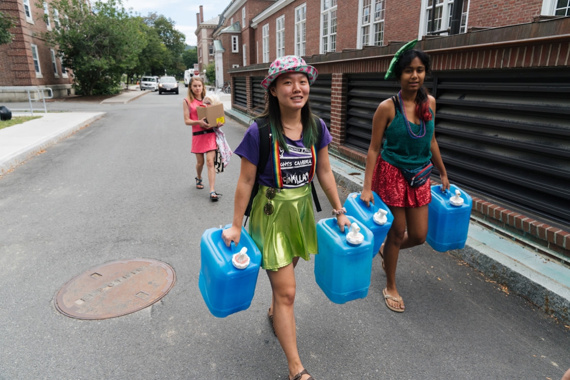 From left, Eliza Jane Schaeffer '20, Emma Demers '20, and Sarishka Desai '20, leave DOC headquarters in Robinson Hall with water and food for an afternoon supply raid on a cabin camping trip.