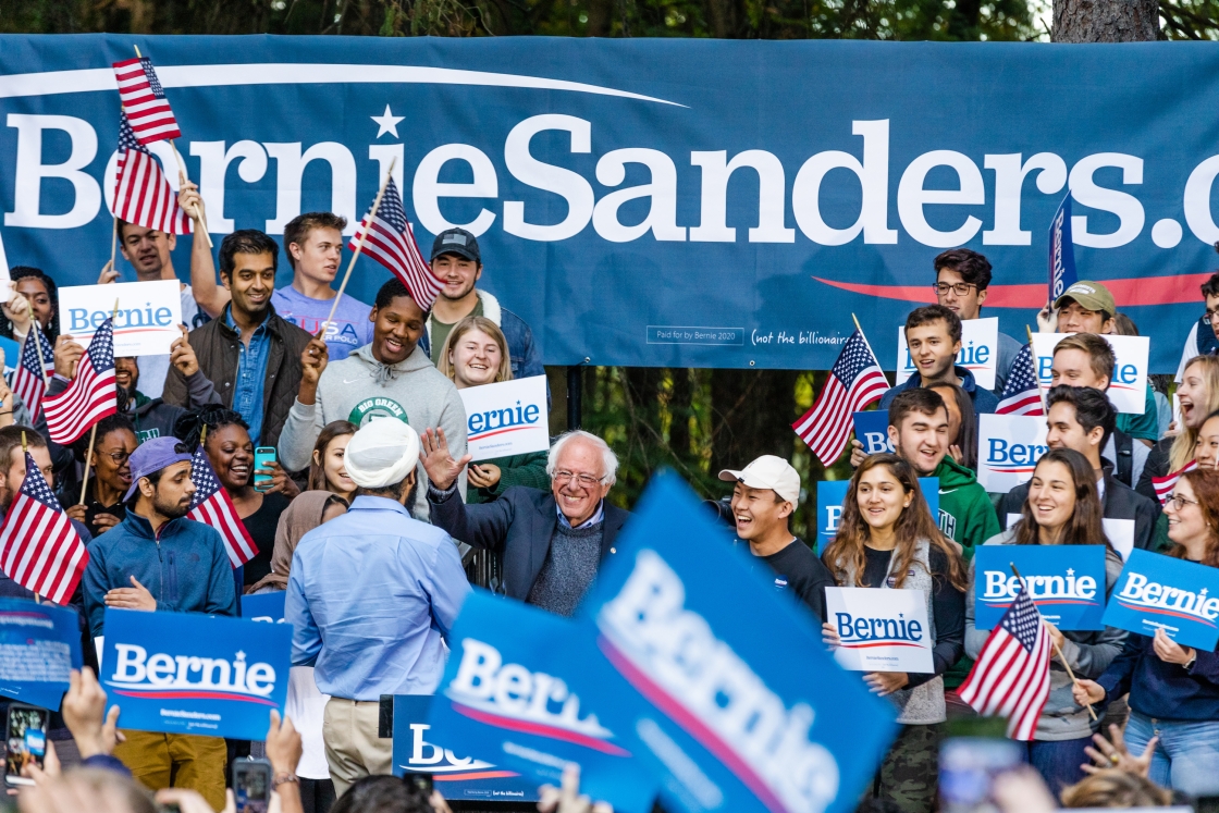 Bernie Sanders and a cheering crowd