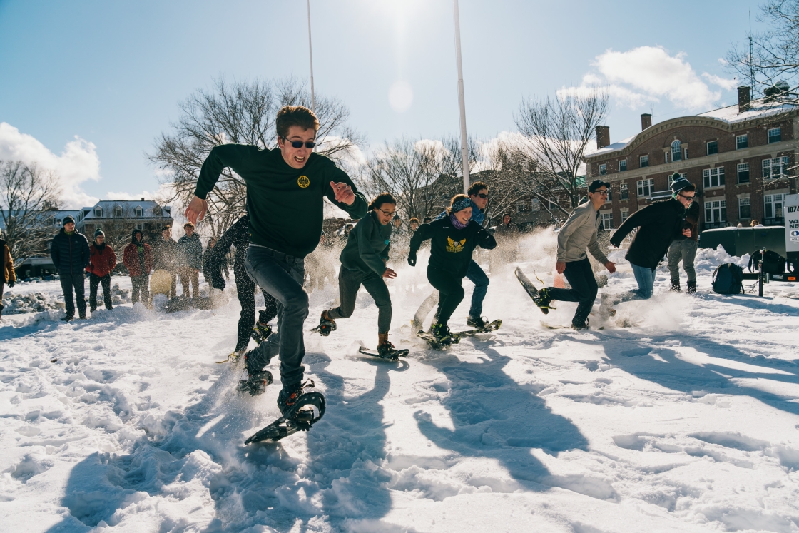 Students enjoying a snowshoe race on the Green during Winter Carnival.