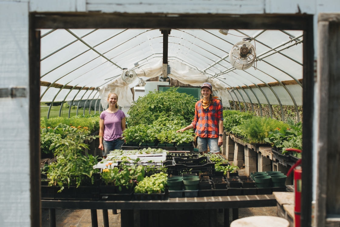 Farm Manager Laura Braasch and Molly McBride '14 inside the greenhouse at the Organic Farm.