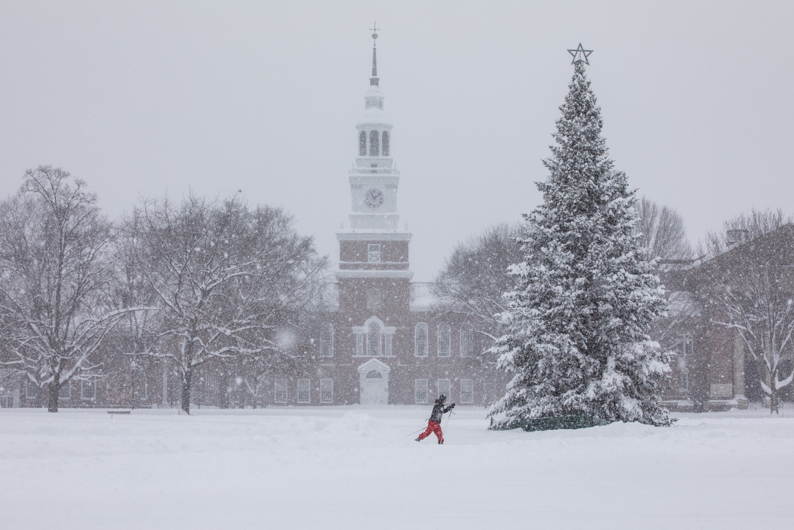 Student walks in front of Baker-Berry Library on December 16, 2020