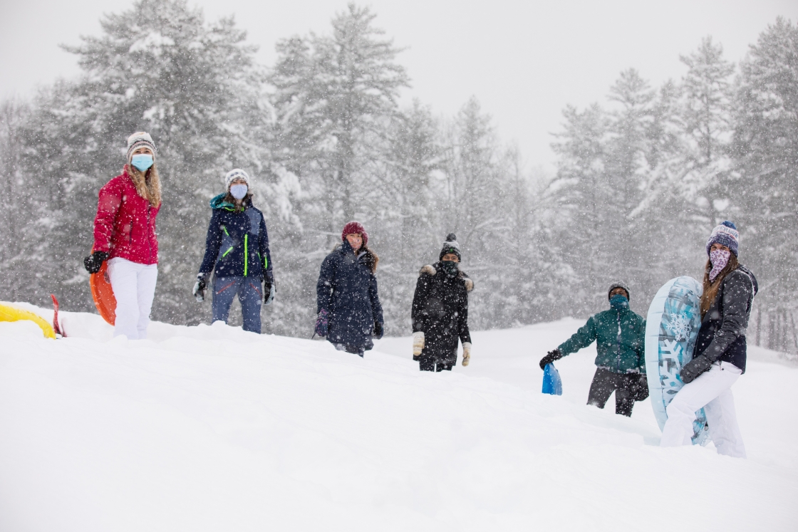 Six students preparing to sled
