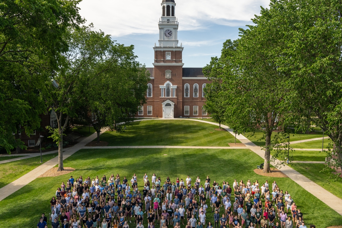 Some members of the Class of 2021 pose for the traditional class photo in a year that has been anything but traditional. The photo is usually taken with Dartmouth Hall as the backdrop. With Dartmouth Hall this year undergoing renovations, the iconic Baker
