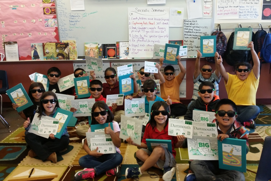 Third-grade students in New Mexico proudly show off Dartmouth swag.