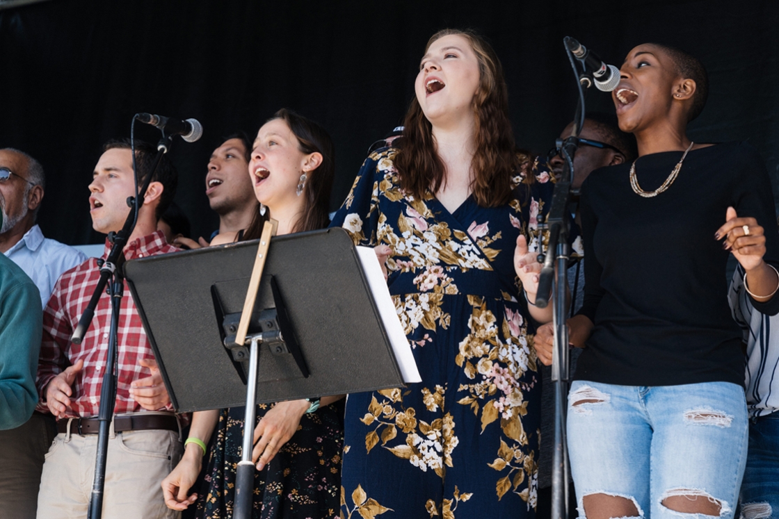 Members of the Dartmouth College Gospel Choir, led by Walt Cunningham, perform at the community cookout on the Green.