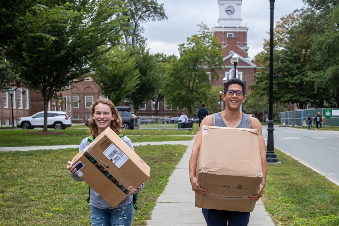 Two students carry boxes as they move back to campus, a common scene in the days leading up to the start of classes.