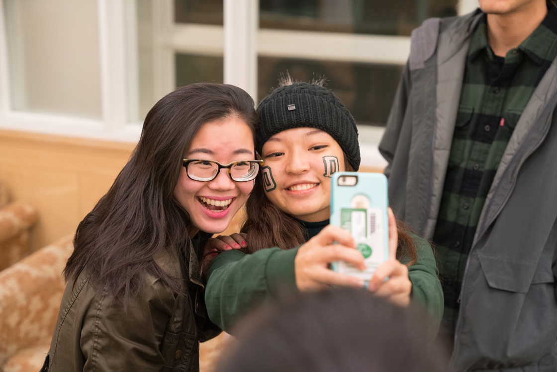 Two students taking selfies