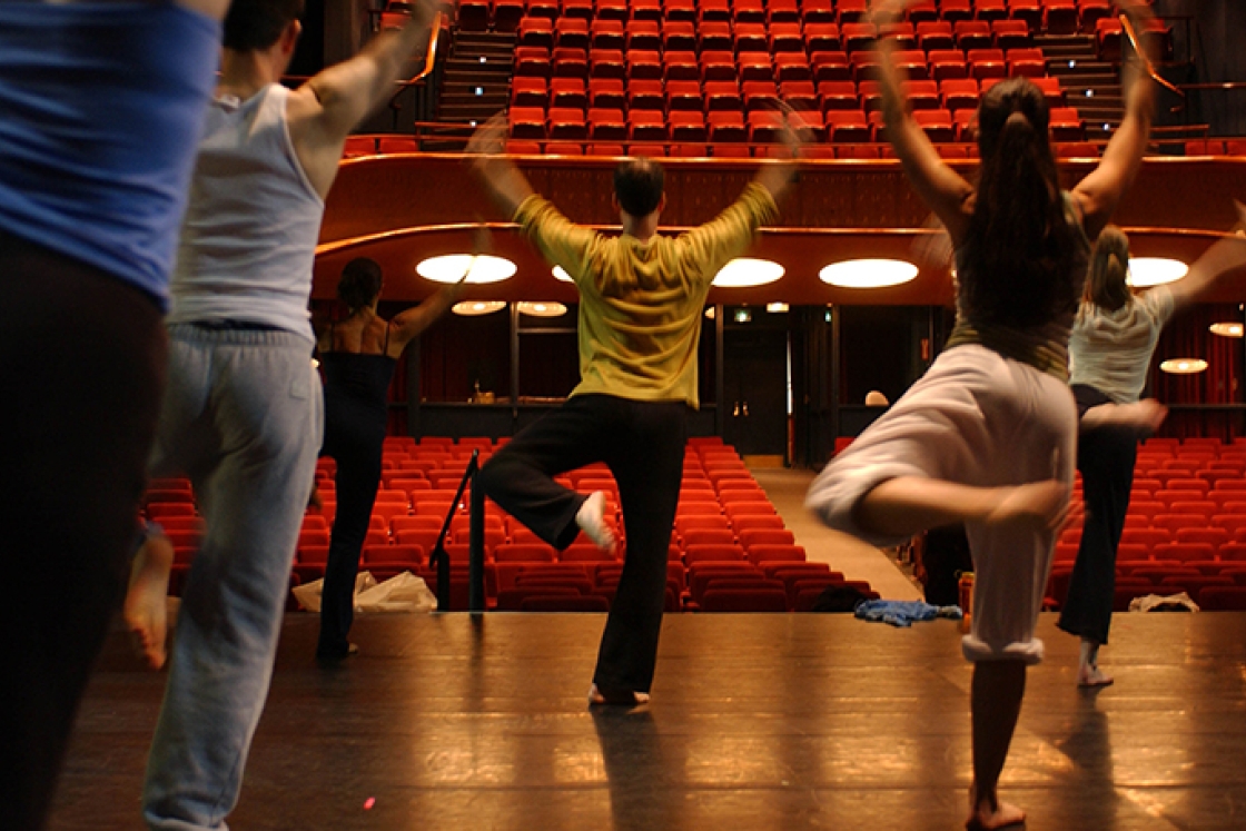 students rehearsing a dance number on stage