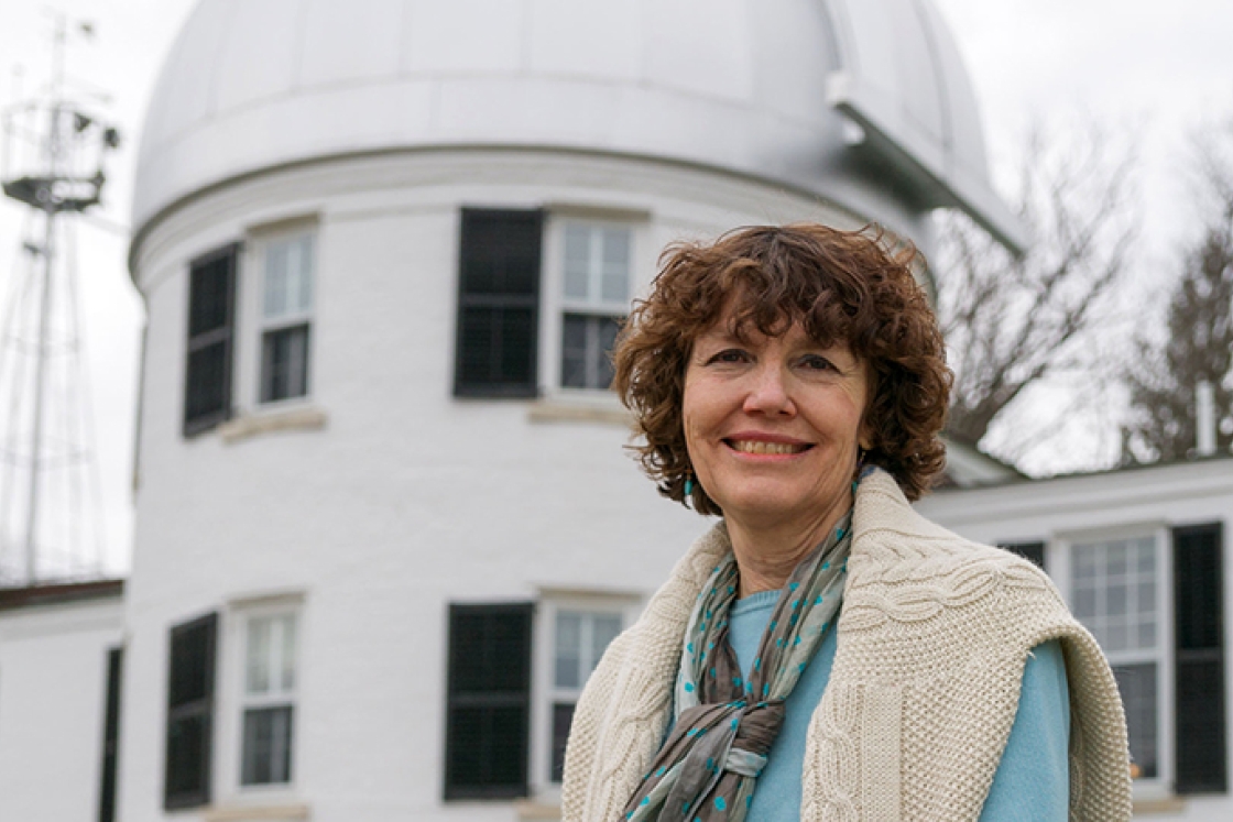 Mary Hudson standing in front of the observatory building