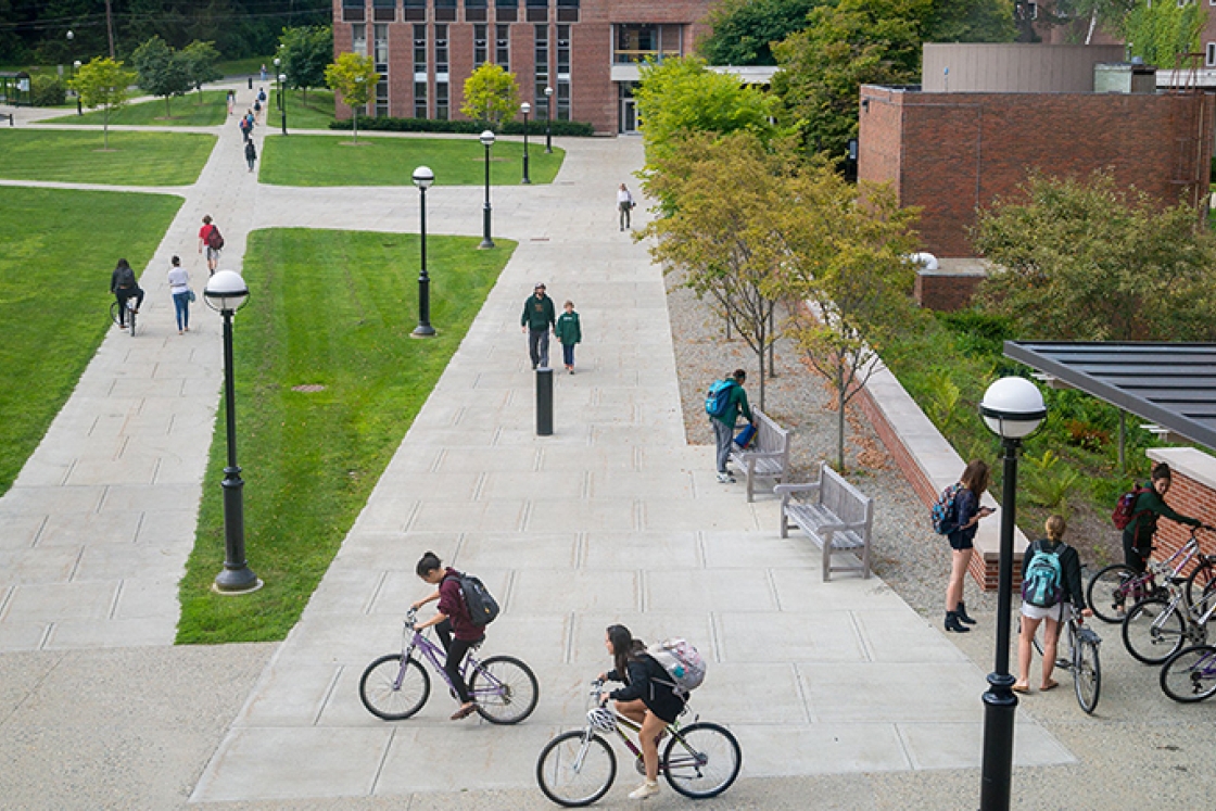 students riding bikes outside the Life Sciences center