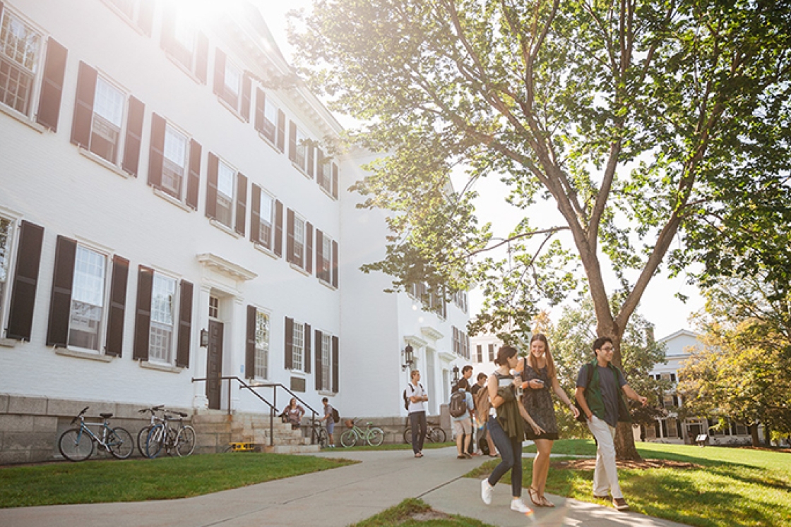 a group of students walking on the sidewalk outside of Dartmouth Hall
