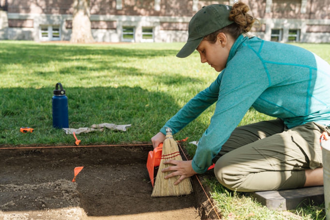 Katie Hoover ’22 helps with an archeological excavation of a mansion buried under the lawn in front of Dartmouth Library’s Baker-Berry Library.