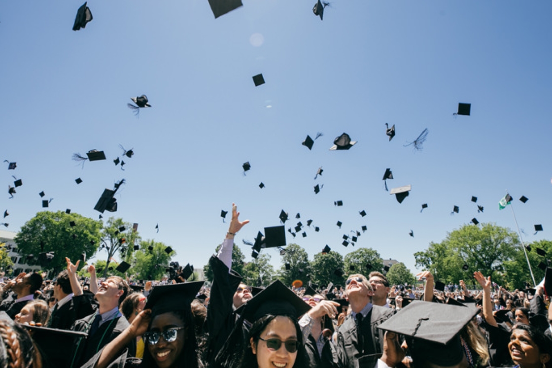 Students throw their caps in the air at the end of the 2019 commencement ceremony