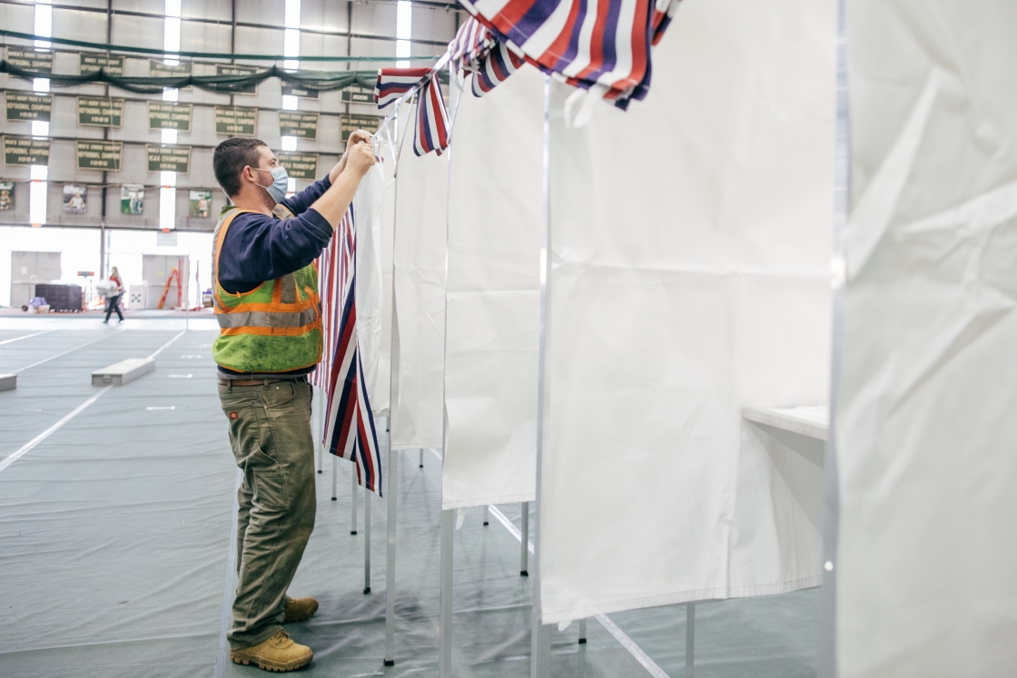 Election worker assembling voting booths