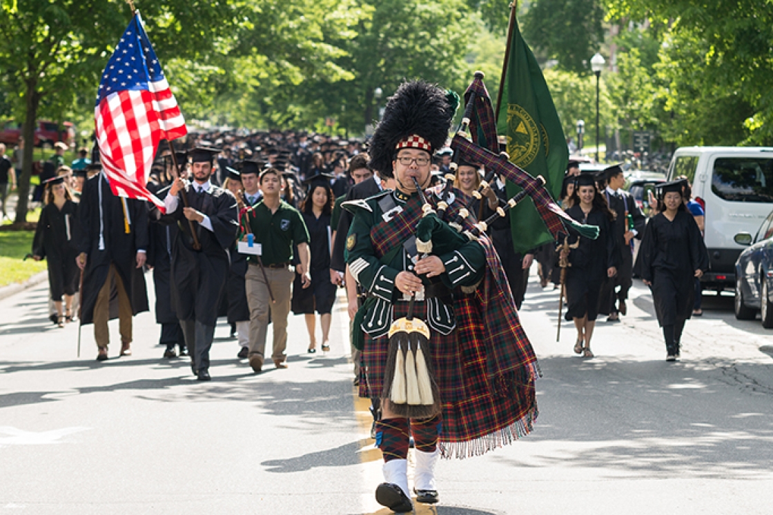 Joshua Marks leading the commencement procession with his bagpipes
