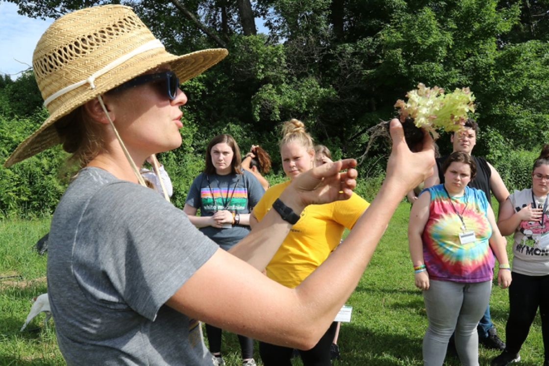 : At the Dartmouth Organic Farm, SEAD scholars—who were on campus for a week in June to experience college life—listen as farm program manager Laura Braasch explains how to plant lettuce.
