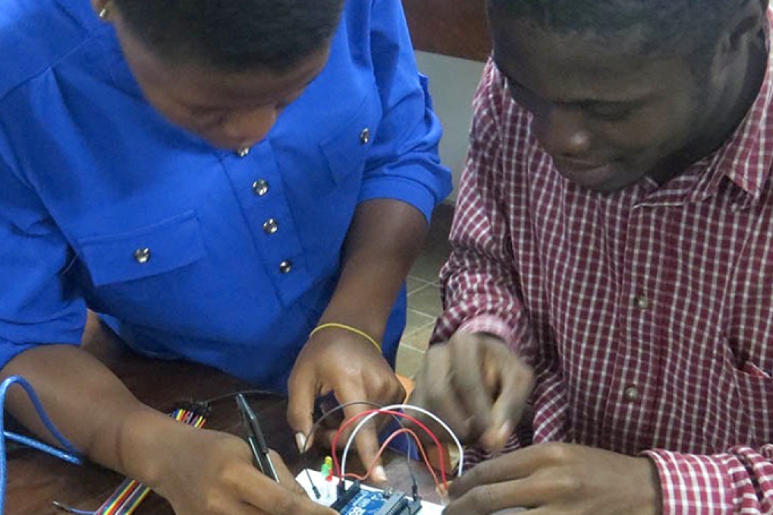 two students building a circuit board
