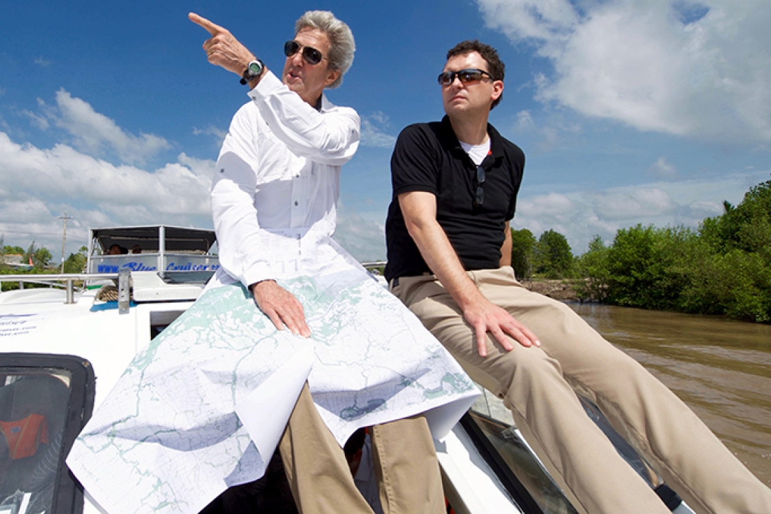 former Secretary of State John Kerry and Dartmouth history professor Edward Miller traveling the Mekong River Delta on a boat