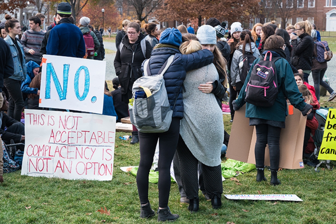students hugging during a protest on the Green.