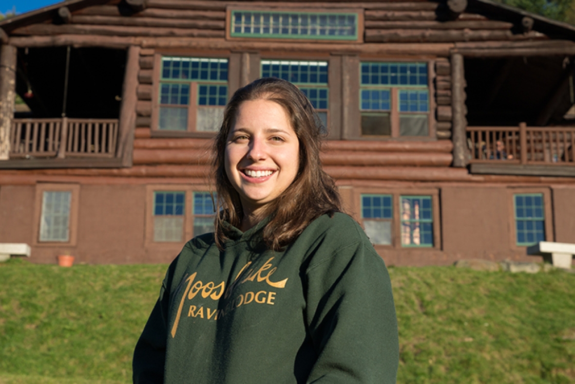 Maddie Lesser standing in front of Moosilauke Lodge