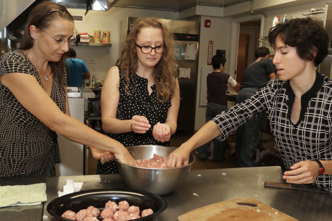 Dartmouth staff members, from left, Lisa Sharp Grady, Nicole Westervelt, and Alexandra Stein ’06 prepare dinner at the Upper Valley Haven.