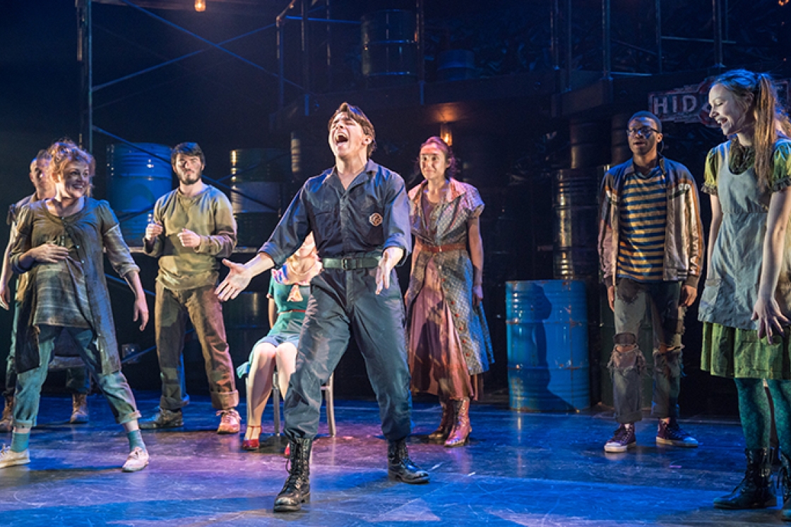 the cast of Urinetown performing on stage