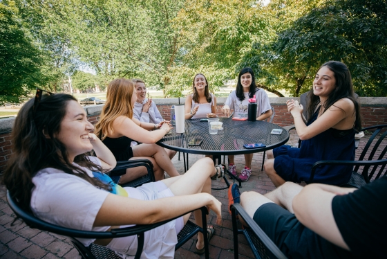 Girls sitting around table laughing