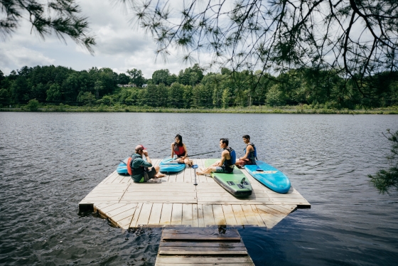 Gunnar Johnson, the coordinator for educational programming, leads an Outdoor Programming Office trip on the Connecticut River, teaching students how to use stand-up paddleboards.