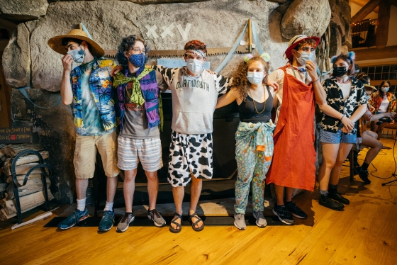 Students stand in Moosilauke Lodge with masks on