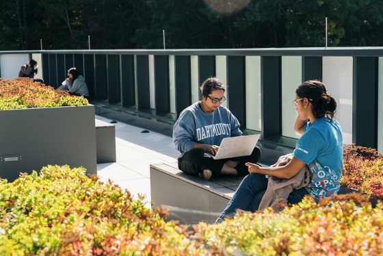 Two students studying on the rooftop of Anonymous Hall.