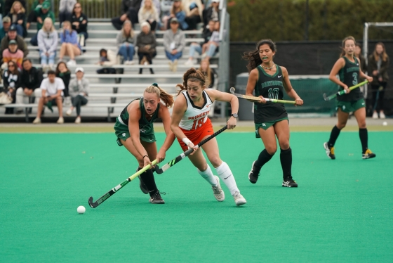 Dartmouth player and Princeton player fight over the ball