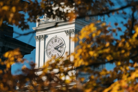Baker Tower clock framed by fall foliage
